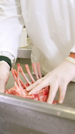 Butcher-arranging-red-meat-on-worktop