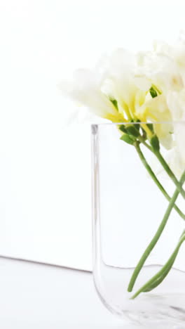 Stack-of-books,-blank-board,-flower-vase,-cup-of-tea-and-table-lamp