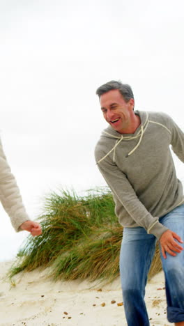 Mature-couple-enjoying-on-beach