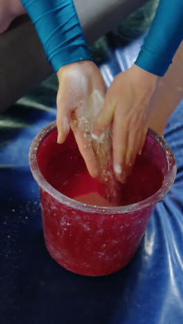 Gymnast-putting-chalk-powder-on-her-hands