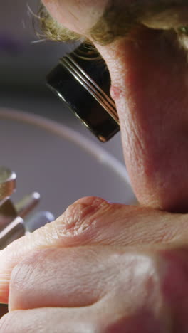 Close-up-of-horologist-using-a-machine