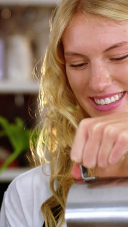 Smiling-waitress-making-cup-of-coffee