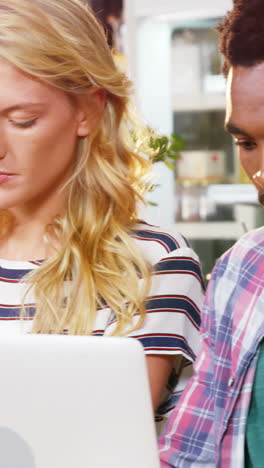 Group-of-friends-using-mobile-phone-and-laptop