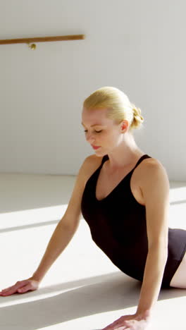 Ballerina-performing-stretching-exercise