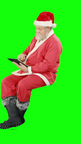 Santa-claus-using-digital-tablet