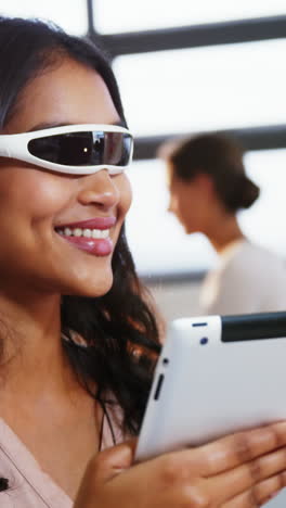 Woman-using-virtual-reality-glasses-and-digital-tablet