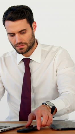 Businessman-using-laptop-at-his-desk