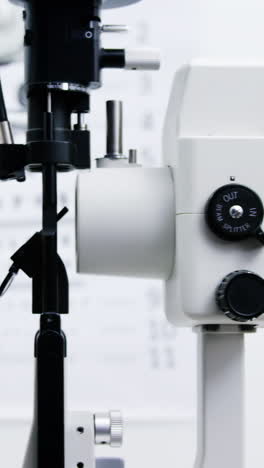 Optometrist-examining-female-patient-on-slit-lamp