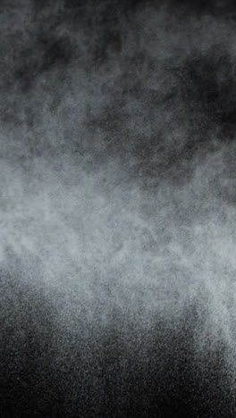 White-dust-powder-blowing-against-black-background