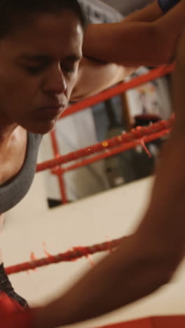 Two-female-boxers-practicing-in-boxing-ring