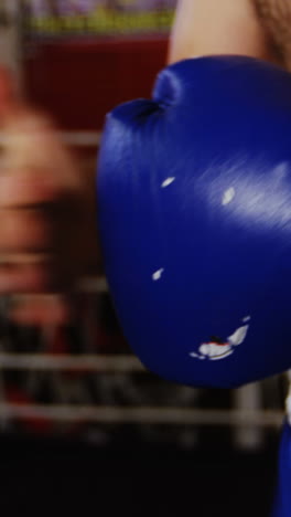 Boxers-wearing-boxing-gloves-in-fitness-studio