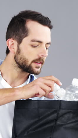 Man-holding-bag-with-bottles