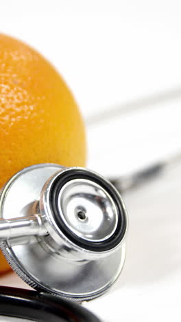 Stethoscope-and-orange-fruit-on-a-white-background