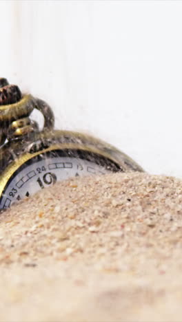 Alarm-clock-in-sand