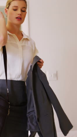 Woman-getting-ready-for-office-in-bedroom