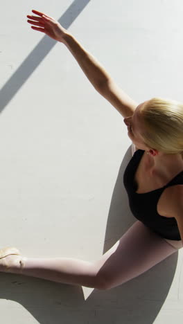 Ballerina-performing-stretching-exercise