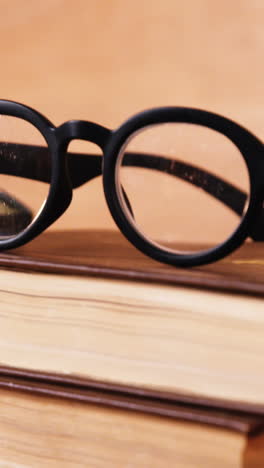 Stack-of-books-with-spectacles-on-a-desk