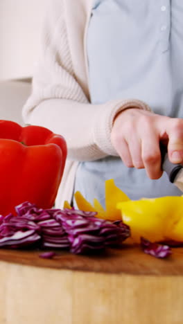 Woman-cutting-vegetables-in-kitchen