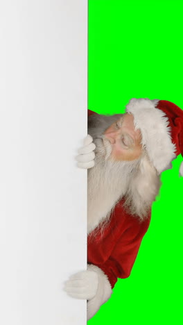 Überraschter-Weihnachtsmann,-Der-Sich-Hinter-Einem-Weißen-Bildschirm-Versteckt