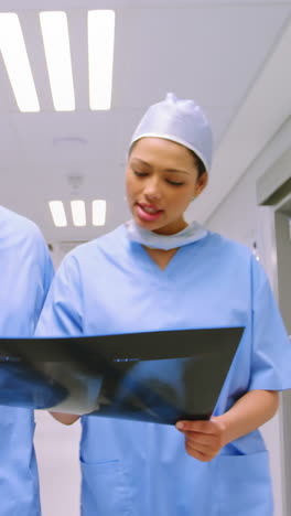 Surgeon-and-colleague-discussing-over-an-x-ray