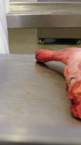 Mid-section-of-butchers-slicing-red-meat