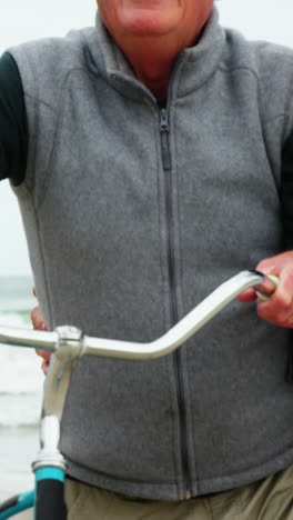 Happy-senior-couple-walking-with-their-bicycle