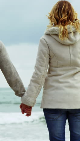 Mature-couple-enjoying-on-beach