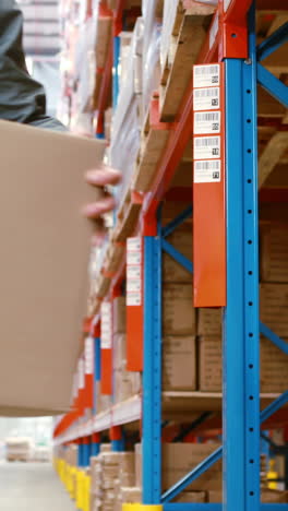 Warehouse-worker-looking-at-package