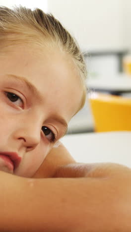 Sad-girl-lying-on-desk-in-class