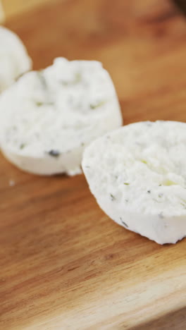 Slices-of-cheese-on-wooden-board