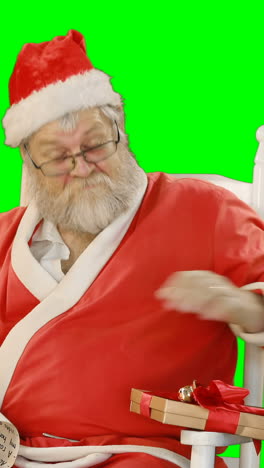 Santa-claus-holding-scroll-and-gift-box