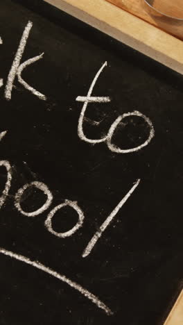 Close-up-of-chalkboard-with-colored-pencil-and-crayon