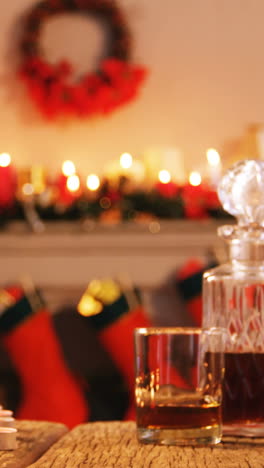 Bottle-of-whiskey,-glass-and-gift-box-on-wooden-table