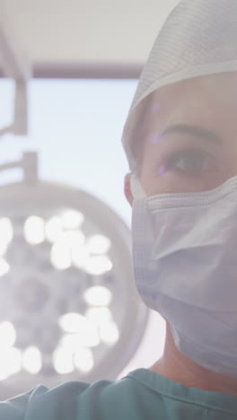 Portrait-of-surgeons-standing-with-arms-crossed-in-operation-room