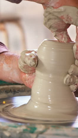 Mid-section-of-potter-making-pot