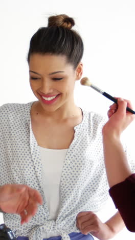 Female-model-posing-and-getting-face-make-up