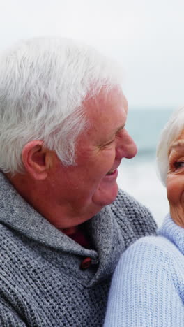 Senior-couple-embracing-each-other-on-the-beach