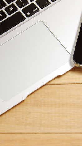 Laptop-and-mobile-phone-on-wooden-plank