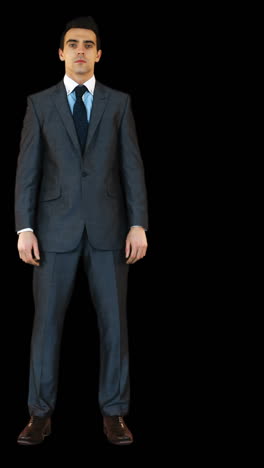 Businessman-standing-against-black-background