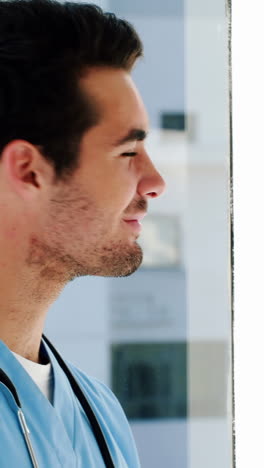 Portrait-of-male-doctor-writing-on-a-clipboard