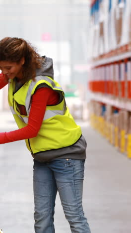 Female-warehouse-worker-moping-floor