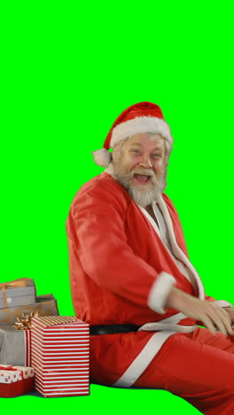 Santa-claus-with-gift-box-riding-on-green-screen