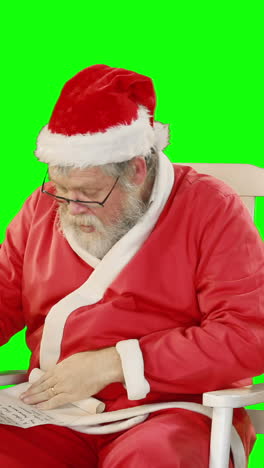 Santa-claus-holding-scroll-and-gift-box