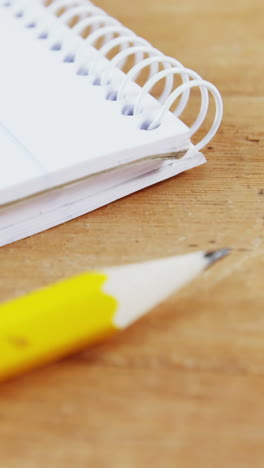 Notepad-and-pencil-on-wooden-plank