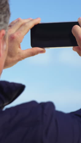 Reifer-Mann,-Der-Die-Aussicht-Vom-Mobiltelefon-Aus-Fotografiert