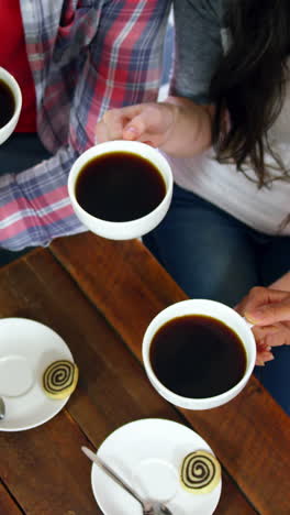 Group-of-friends-toasting-cup-of-coffee