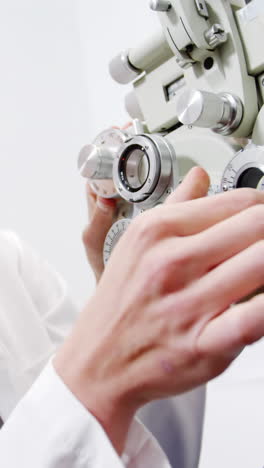 Female-optometrist-examining-young-patient-on-chiropter