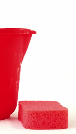 Close-up-of-plastic-bucket-and-cleaning-sponge