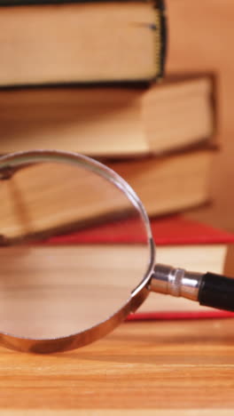 Magnifying-glass-with-a-book-on-desk