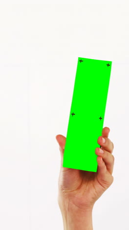 Hand-of-a-woman-holding-green-pla-card